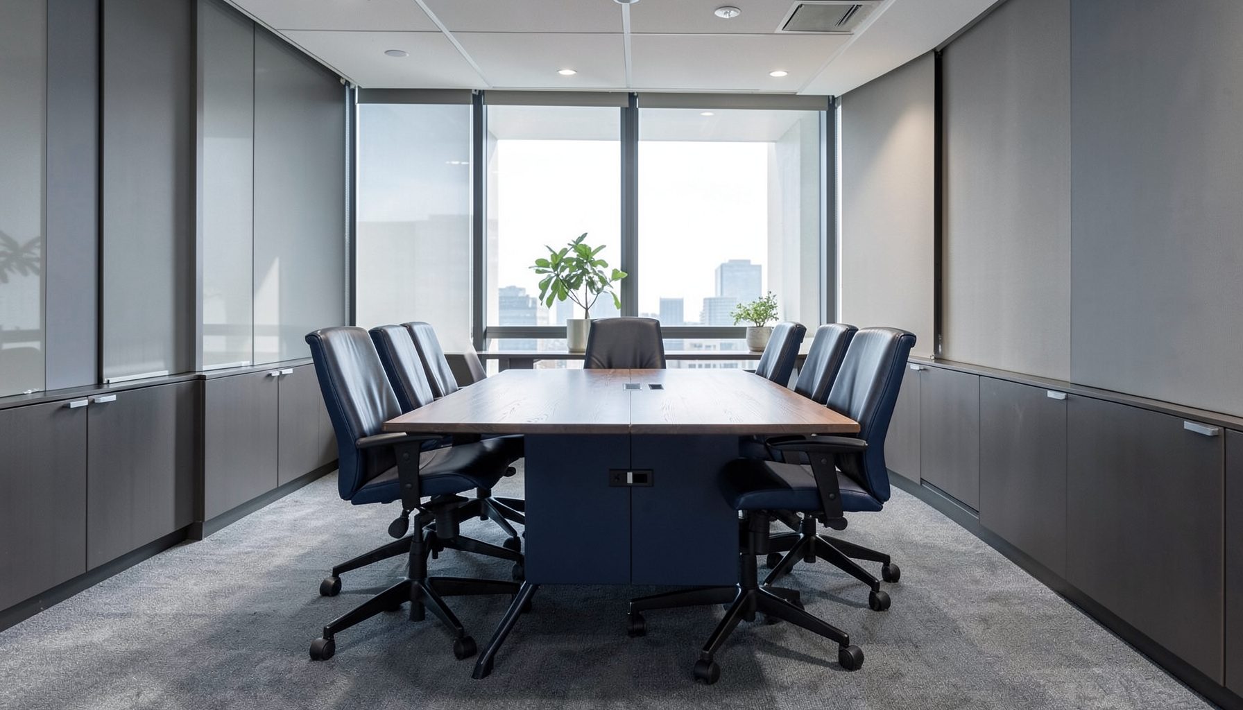 Professional office interior with a conference table and leather chairs, muted navy and gray tones